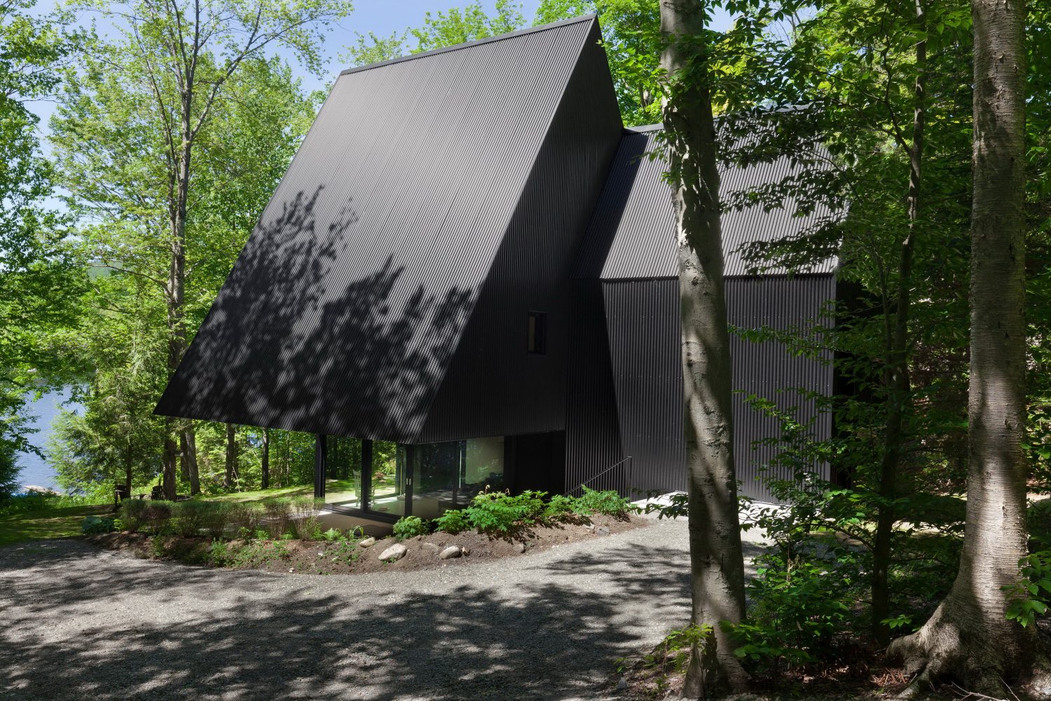 Fahouse | Black Cottage with Steep Gabled Roofs