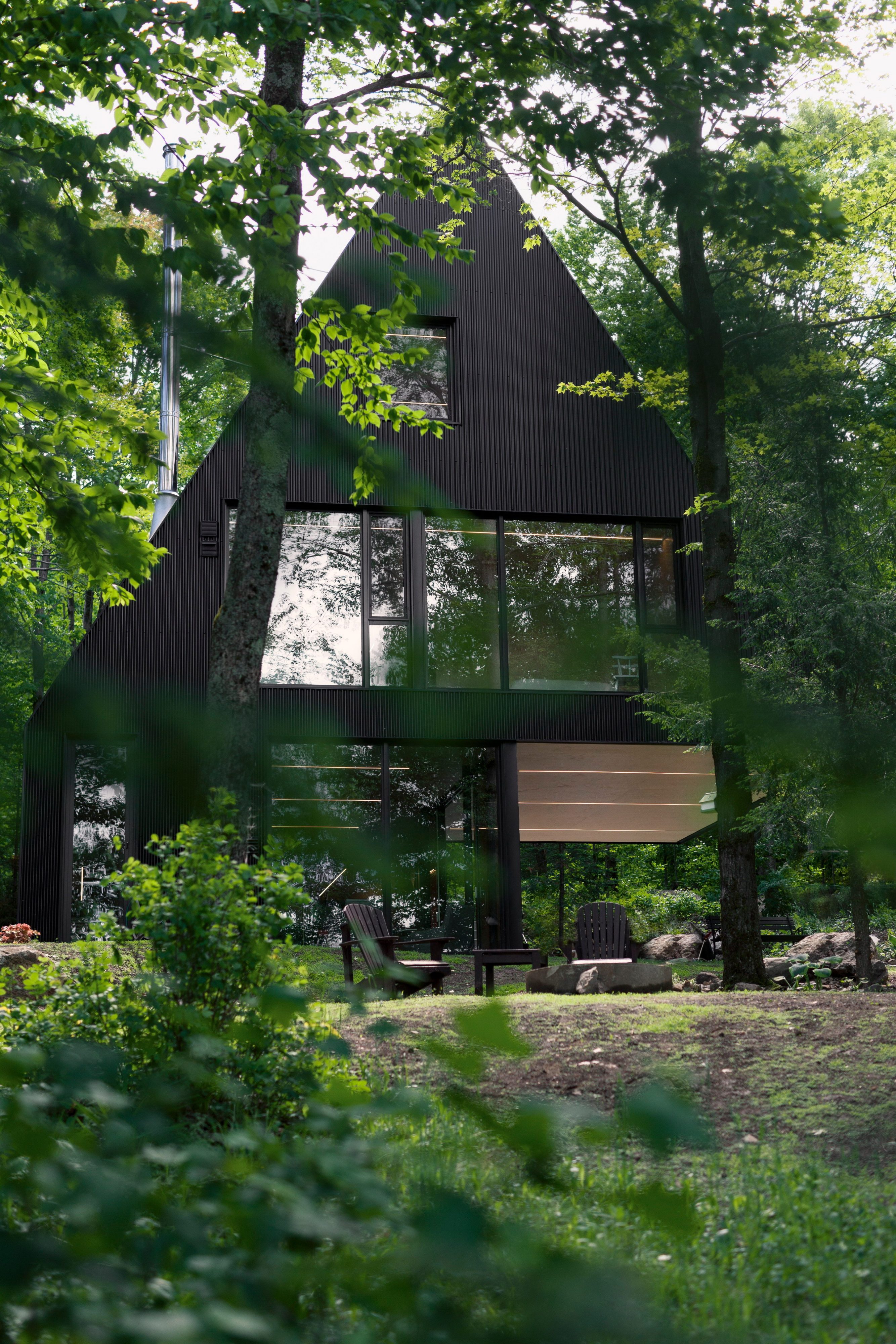 Fahouse | Black Cottage with Steep Gabled Roofs